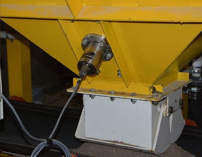 Sensor installed in an aggregate bin cone